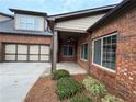 Brick exterior with a covered patio and attached garage offers both style and convenience at 120 Chastain Nw Rd # 1104, Kennesaw, GA 30144
