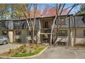Exterior view of charming townhome with landscaped yard and parking at 112 Rosaire Nw Pl, Atlanta, GA 30327