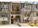 Exterior view of charming townhome with walkways to unit entrances at 112 Rosaire Nw Pl, Atlanta, GA 30327