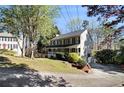 Well-maintained home with a long driveway and lush landscaping at 1472 Hartman Sw Dr, Lilburn, GA 30047