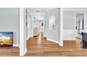 Bright hallway features hardwood floors, blue walls, white trim, and archway leading to the living areas at 3670 Cedar Springs Ln, Loganville, GA 30052