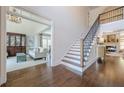 Bright foyer with staircase, hardwood floors, and an open view into the living room at 4732 Corina Ne Pl, Roswell, GA 30075