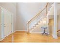 Bright foyer with hardwood floors, a staircase with white railings, and a white front door with sidelights at 6227 Braidwood Nw Way, Acworth, GA 30101
