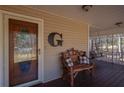 Relaxing covered front porch with bench seating for enjoying the outdoors at 165 Carriage Gate Dr, Sharpsburg, GA 30277