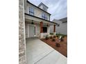 Inviting front entryway featuring a covered porch, wooden support columns, and fresh landscaping at 376 Waterbluff Dr, Mableton, GA 30126