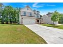 Beautiful two-story home with a two-car garage and an extra-long driveway and landscaped front yard at 376 Waterbluff Dr, Mableton, GA 30126