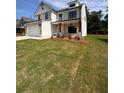 A beautiful two-story house boasts a well-manicured lawn, brick accents, and a side-entry two-car garage at 376 Waterbluff Dr, Mableton, GA 30126