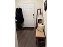 Welcoming entryway features hardwood floors, a bench, a mirror, and a coat rack at 1302 Speckle Park Way, Stockbridge, GA 30281