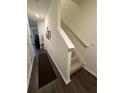 Bright hallway with hardwood floors leads to the staircase and other areas of the home at 1302 Speckle Park Way, Stockbridge, GA 30281