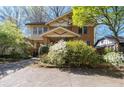 Charming two-story brick home featuring a covered porch and beautifully landscaped yard at 2265 E Lake Ne Rd, Atlanta, GA 30307