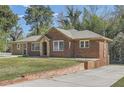 Beautiful home with brick accents, a well-maintained lawn, and a long driveway at 2836 Waters Sw Rd, Atlanta, GA 30354