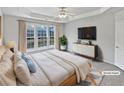 Staged bedroom featuring a ceiling fan and large windows at 3905 Delfaire Trce, Cumming, GA 30040
