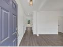 Bright foyer featuring wood-look flooring and white walls, offering a glimpse into the home's modern design at 372 Waterbluff Dr, Mableton, GA 30126