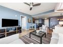 Well-lit living room with hardwood floors, comfortable seating, and an open view into the dining area at 3338 Peachtree Ne Rd # 2804, Atlanta, GA 30326