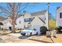 Traditional two-story home featuring light siding, black shutters and a driveway with a parked car at 344 Springbottom Ct, Lawrenceville, GA 30046