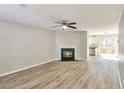 Bright living room with a cozy fireplace and open layout, featuring light wood flooring at 344 Springbottom Ct, Lawrenceville, GA 30046