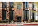 Building entrance featuring brick facade with large windows and beautiful landscaping around the walkway at 170 Boulevard Se # 104E, Atlanta, GA 30312