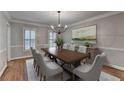 Formal dining room with wood floors, modern chandelier and neutral colors at 10835 Tuxford Dr, Alpharetta, GA 30022
