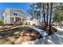 Beautiful exterior view of the home's architecture with well-manicured lawn and mature trees at 585 Sherwood Ne Rd, Atlanta, GA 30324