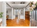 Elegant foyer with hardwood floors, white columns, and a view into adjacent rooms at 2611 Winterthur Main Nw, Kennesaw, GA 30144