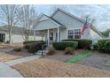 Inviting single-story home with landscaped front yard, short walkway, and an American flag at 4531 Flowering Br, Powder Springs, GA 30127