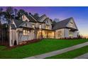 Beautifully lit home at dusk featuring a sprawling lawn and manicured landscaping, perfect for evening gatherings and curb appeal at 4921 Slaton Dr, Acworth, GA 30101