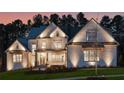 Stunning home at twilight, illuminated to showcase its architectural details and inviting curb appeal in a beautiful neighborhood at 4921 Slaton Dr, Acworth, GA 30101
