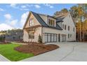Spacious three-car garage with modern glass doors, offering ample parking and curb appeal to this well-maintained home at 4921 Slaton Dr, Acworth, GA 30101