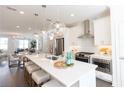 Bright open kitchen featuring a large island, modern stainless steel appliances, and pendant lighting at 5450 Howington Ct # 195, Buford, GA 30518