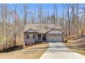 Beautiful brick home with attached garage, offering modern comfort and curb appeal, surrounded by mature trees at 197 Saddleridge Dr, Bremen, GA 30110