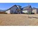 Inviting single Gathering home with covered porch, complemented by a well-manicured lawn at 60 Streamside Dr, Covington, GA 30016