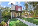 Contemporary two-story home featuring a covered porch, brick accents, and a manicured front yard at 1171 State St # B, Atlanta, GA 30318