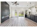 Bright living room with a modern fireplace, an open floorplan, hardwood floors and backyard access at 2312 Herring Sw Rd, Atlanta, GA 30311