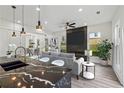 Open-concept living room featuring a modern fireplace, stylish furnishings, and seamless flow into the dining area at 2312 Herring Sw Rd, Atlanta, GA 30311