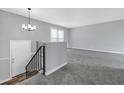 Bright, spacious living room with new carpeting and plenty of natural light from the window at 4564 Cypress Ridge Ct, Stone Mountain, GA 30083