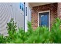 Inviting front entrance with brick facade, gray door, and manicured landscaping at 656 Avondale Park Cir, Decatur, GA 30032