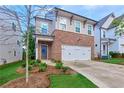 Charming two-story home featuring brick accents, a two-car garage, and a well-manicured lawn at 656 Avondale Park Cir, Decatur, GA 30032