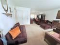 Spacious living room featuring cozy furniture, bright windows, and an adjacent dining area, perfect for Gathering gatherings at 1979 Se Bencal Se Dr, Atlanta, GA 30316