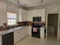 Traditional kitchen with white cabinets, tile countertops, and stainless steel appliances at 275 Rose Ivy Ct, Lawrenceville, GA 30043