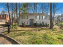 Charming two-story home with gray siding and lush front yard at 3274 Adelade Ct, Lithonia, GA 30038