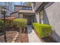 Attractive home entrance with decorative landscaping, a dark-stained front door, and a walkway at 2914 Lenox Ne Rd # 12, Atlanta, GA 30324