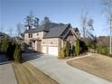 Beautiful two-story brick home with a two-car garage and a well-manicured lawn at 12640 Hearthstone Way, Alpharetta, GA 30009