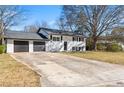 Charming home showcasing a two-car garage, a well-maintained lawn, and a classic design at 6650 Baldwin Ct, Riverdale, GA 30274