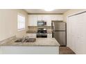 Stylish kitchen with granite countertops, stainless steel appliances, and white cabinets at 1059 Buckboard Ct, Douglasville, GA 30134