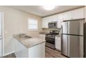 Modern kitchen featuring stainless steel appliances, granite countertops, and ample cabinet space at 1059 Buckboard Ct, Douglasville, GA 30134