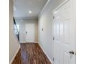 Hallway view featuring hardwood floors and white doors leading to other rooms at 169 Parkview Place Dr, Mcdonough, GA 30253