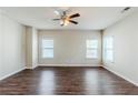 Spacious living room with hardwood floors, ceiling fan, and plenty of natural light at 169 Parkview Place Dr, Mcdonough, GA 30253