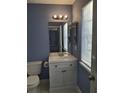 Cozy bathroom with a white vanity, ample lighting, and a neutral color scheme at 851 Hedge Garden Ct, Stone Mountain, GA 30088