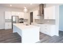 Modern kitchen featuring white cabinets, stainless steel appliances, a central island, and gray subway tile backsplash at 290 Brighton Bend Ln, Acworth, GA 30102