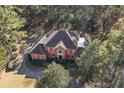 Aerial view of brick home with red shutters, circular drive, and private wooded lot at 440 Dix Lee On Dr., Fayetteville, GA 30215